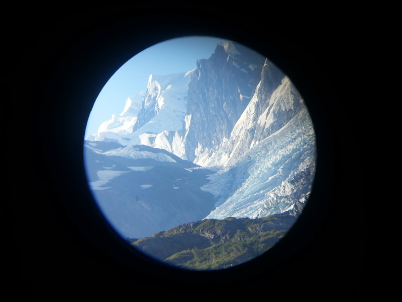 Image of Alaskan glaciers seen through binoculars.
