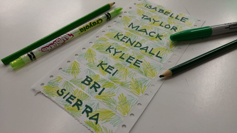Name tags that Kei Lin designed for her summer coaching job. This day's theme were multi-colored tropical leaves in the background and coach names written in dark green ink.